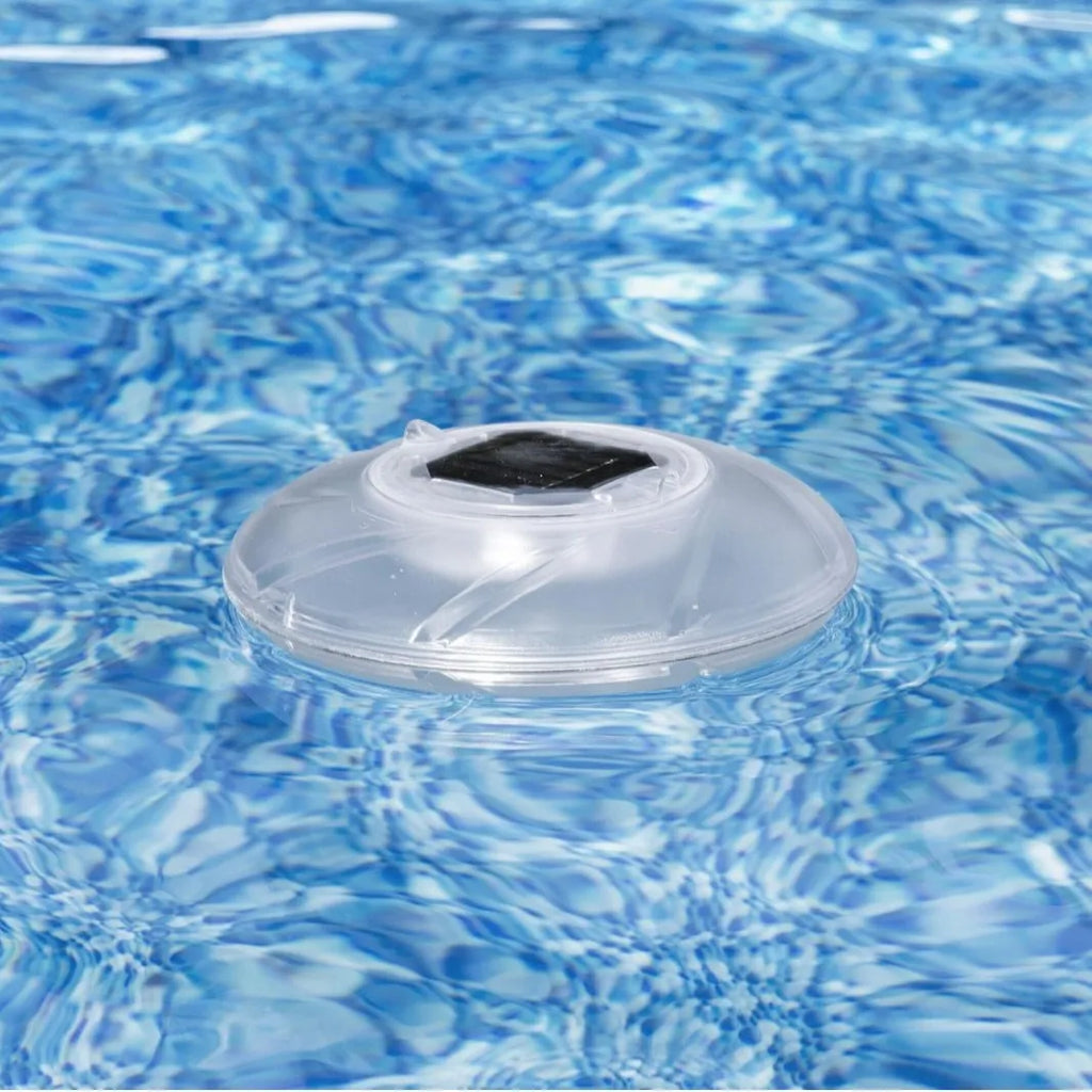 Bestway 58111 solar floating light floating on water surface in outdoor pool at dusk