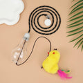 Interactive cat toy with swinging motion hanging from door frame featuring treat reward bulb and retractable elastic cord