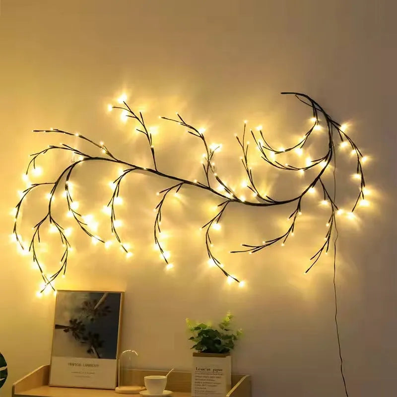 Flexible plastic willow vine LED garland light with warm white lights, shaped on a wall.