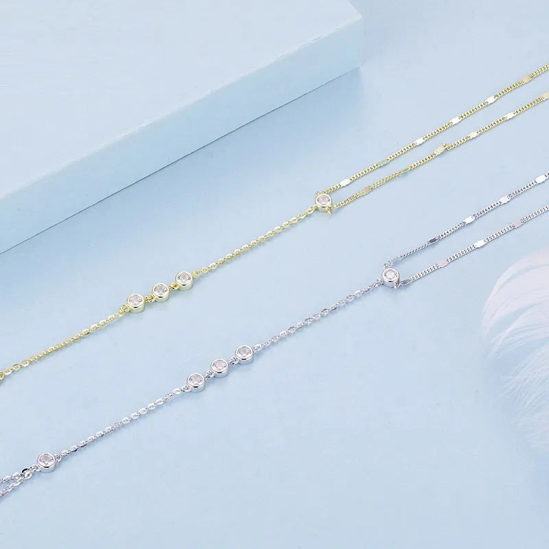 S925 sterling silver tassel bracelet with integrated ring and chain, shown in silver or gold electroplated finish