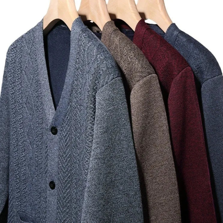 Man wearing a brown and white striped long-sleeved cardigan sweater, buttoned up.