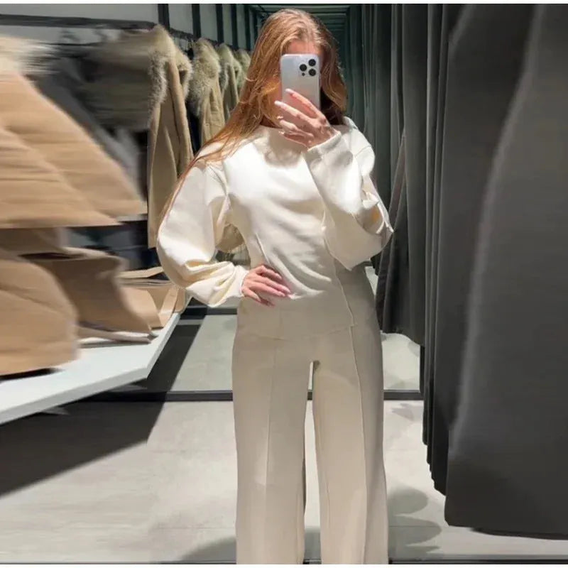 Women's black polyester pleated top and wide leg trousers suit set on a hanger