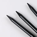 Set of six graphite and three carbonised drawing pencils with wooden casings on a white suction card.