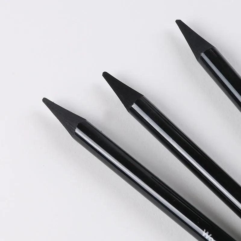 Set of six graphite and three carbonised drawing pencils with wooden casings on a white suction card.