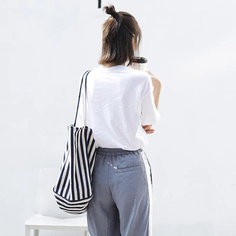 Striped canvas shoulder bag in black, blue, or red with 39cm bottom length, 35cm height, 21cm thickness, and certificate bag.