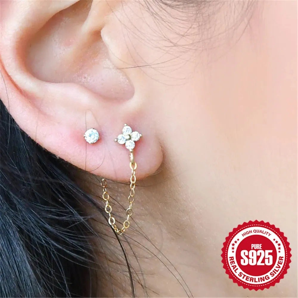 S925 sterling silver geometric drop earring with flower and tassel chain detail in a golden colour.