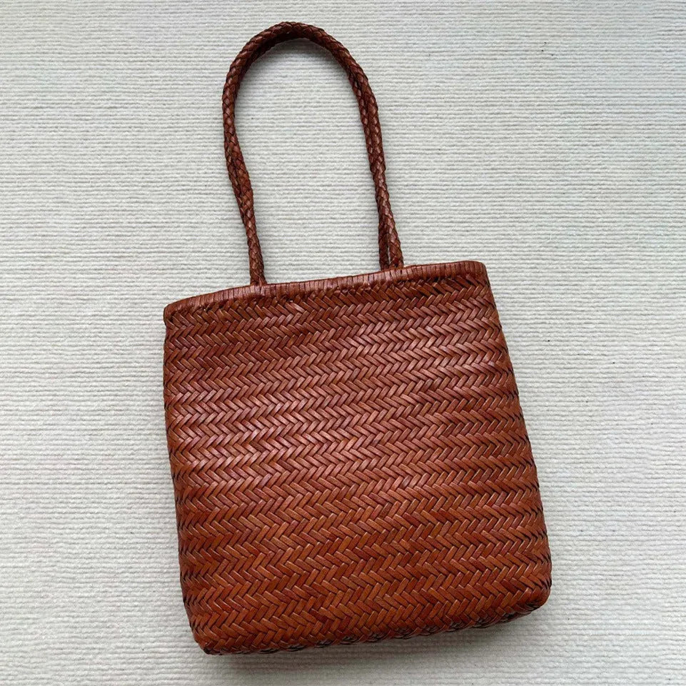 Brown handmade vintage woven leather tote bag with three-dimensional outer pockets.