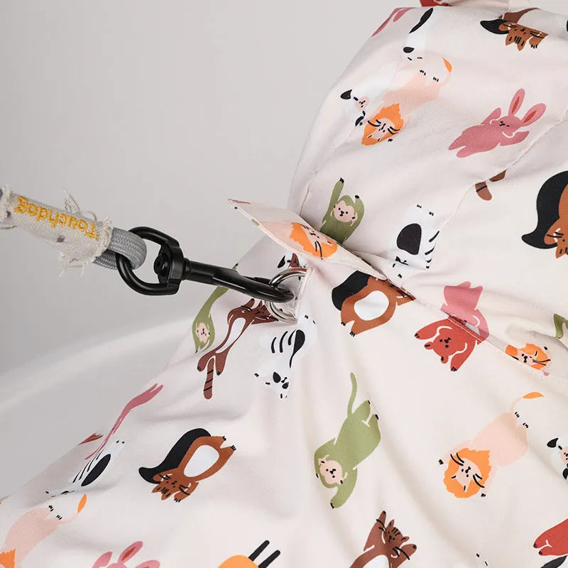 Beige dog raincoat with cartoon animal design showing waterproof PU construction
