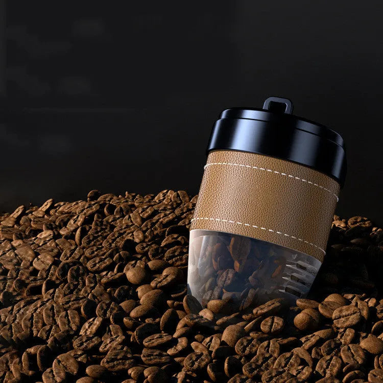 Coffee cup shaped solid car air freshener in black, brown, white, orange, and green colours.