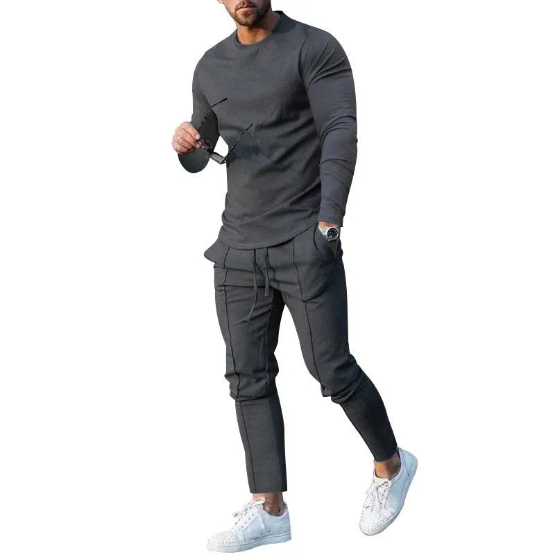 Men's light grey two-piece suit set with long sleeve round neck t-shirt and matching trousers.