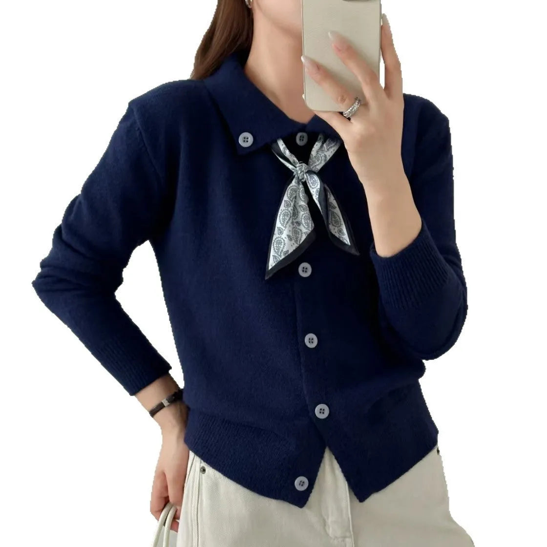 Beige lapel scarf cardigan sweater with long sleeves and splicing detail on a hanger.