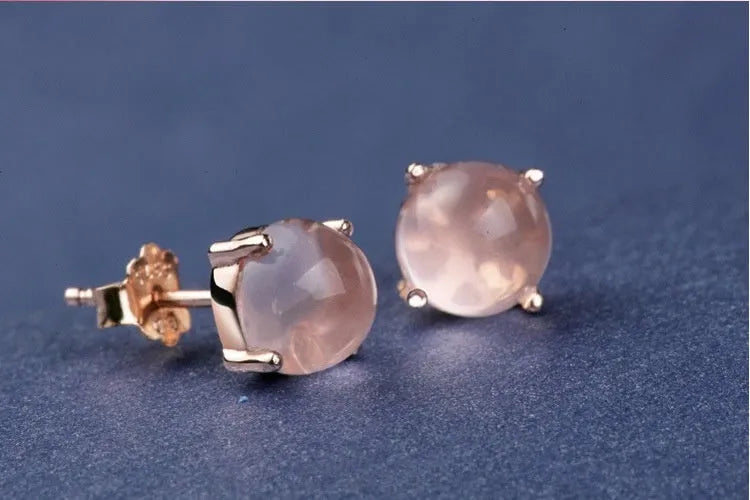 Rose gold plated drop shape stud earrings with a synthetic quartz crystal inlay detail.