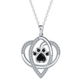 Close-up of dog and cat paw print pendant necklace with cross chain
