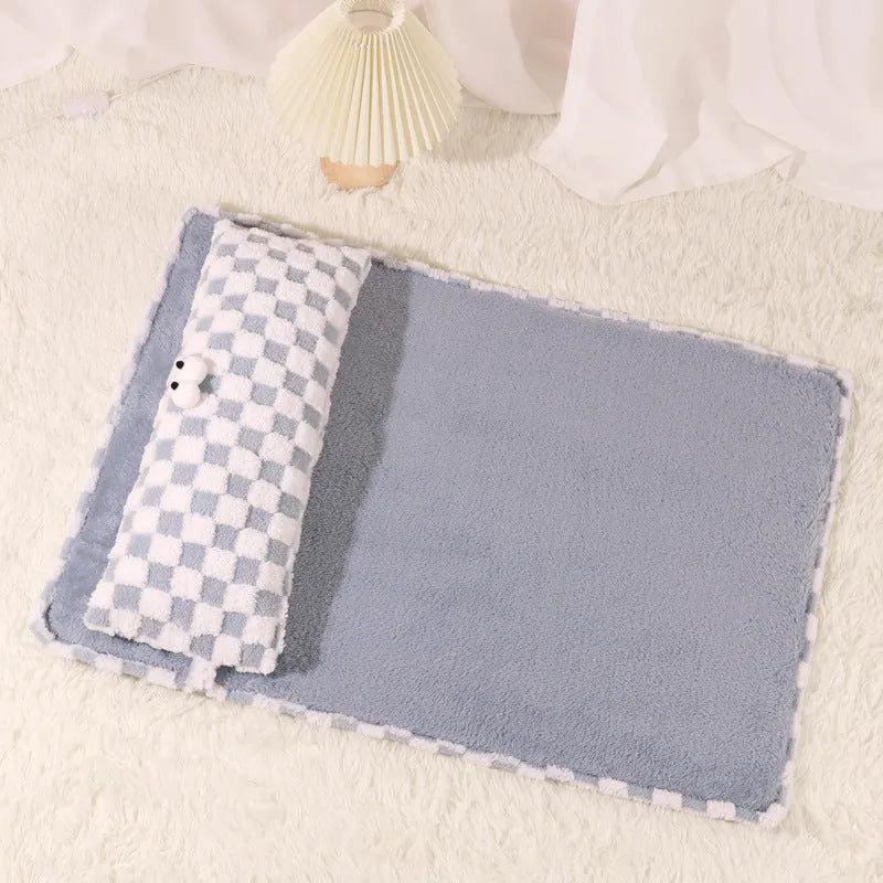 Grey rectangular plush pet cushion for dogs or cats on a wooden floor.