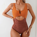 Women's green and black colour-block one-piece nylon swimsuit on a size mannequin.