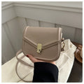 Soft PU leather clamshell shoulder messenger bag in horizontal square shape on adjustable strap.