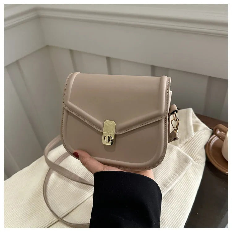 Soft PU leather clamshell shoulder messenger bag in horizontal square shape on adjustable strap.