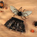 A dog wearing a classic black and white suit-style Halloween costume, showing the full-body design.