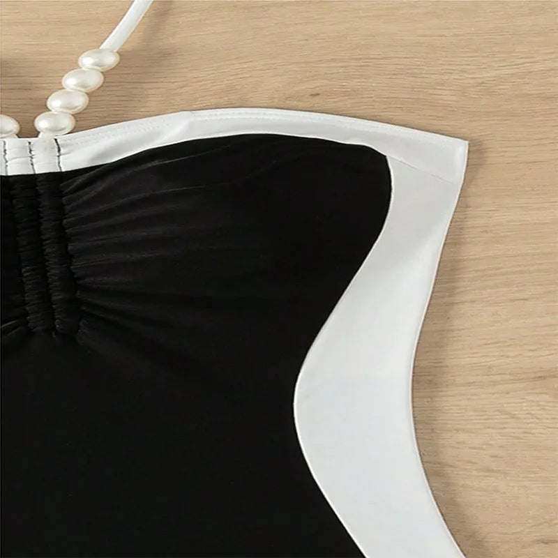 Black and white women's one-piece swimsuit with pearl spaghetti straps, sleeveless slim-fit design.