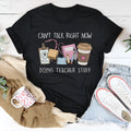 A black, loose-fitting, short-sleeve cotton t-shirt with a round neck on a hanger.
