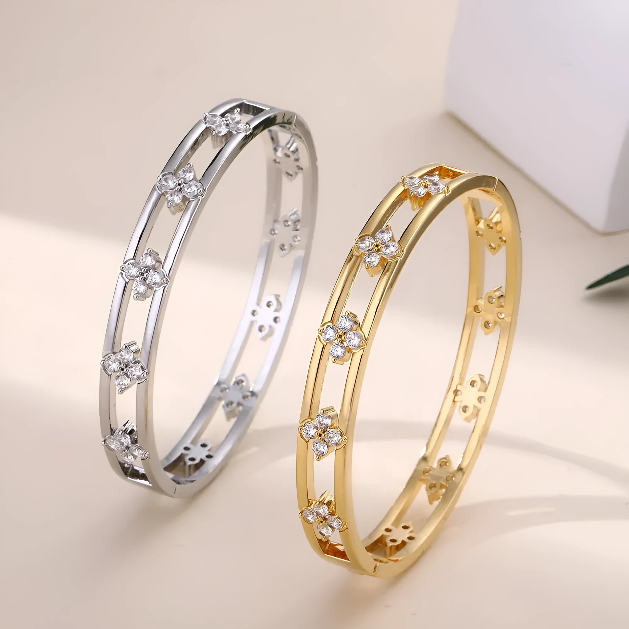Women's simple hollow bracelet with four-leaf clover charm in gold or silver finish