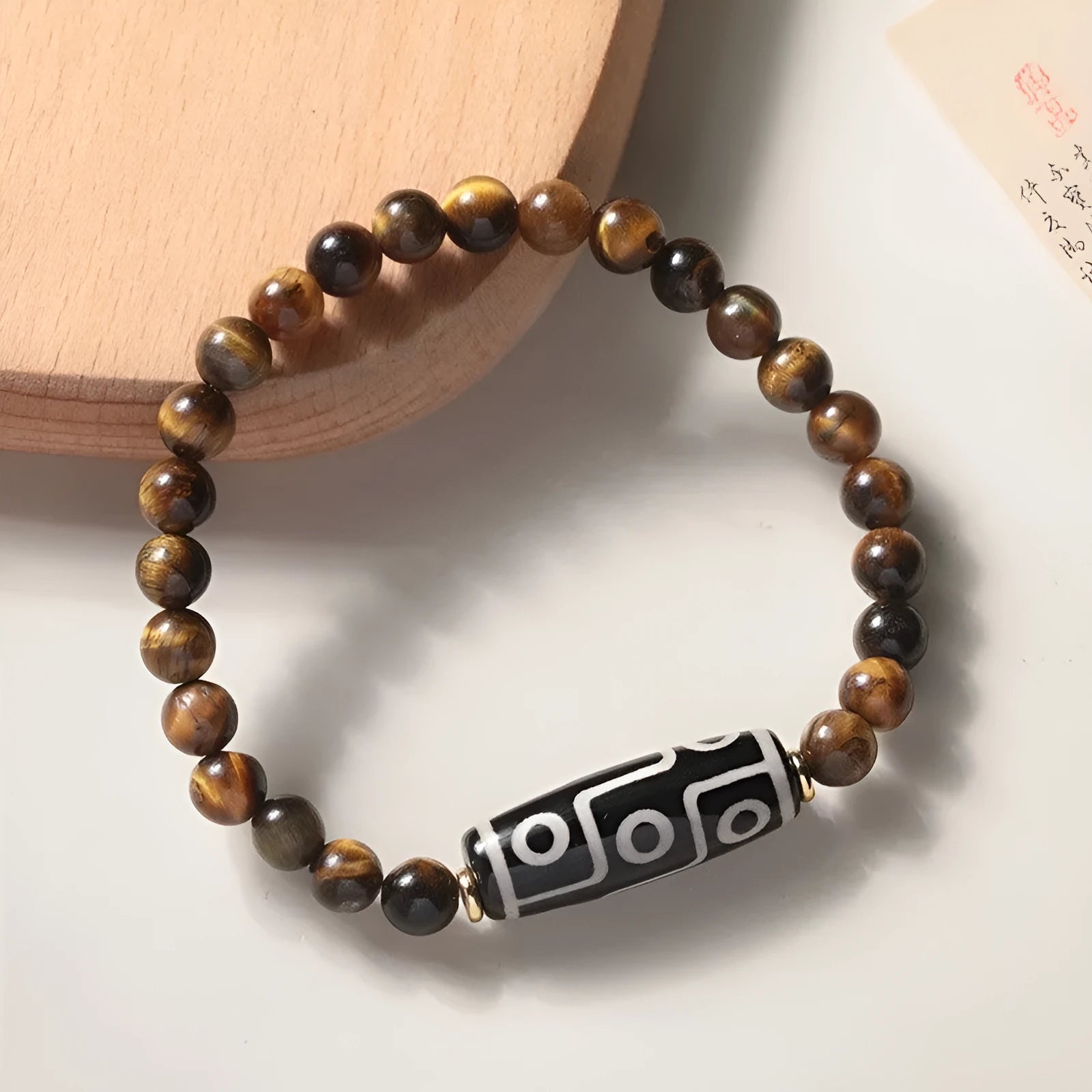 Single tigereye bead ethnic Buddha bracelet on wrist, showing simple rosary style.