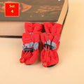Set of four soft-soled cloth dog shoes for pets in assorted colours including red, blue, and black.