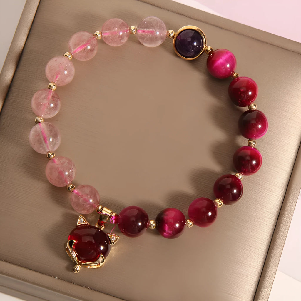 Simple women's bracelet made of transparent strawberry crystal beads on a black elastic rope.