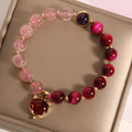 Simple women's bracelet made of transparent strawberry crystal beads on a black elastic rope.