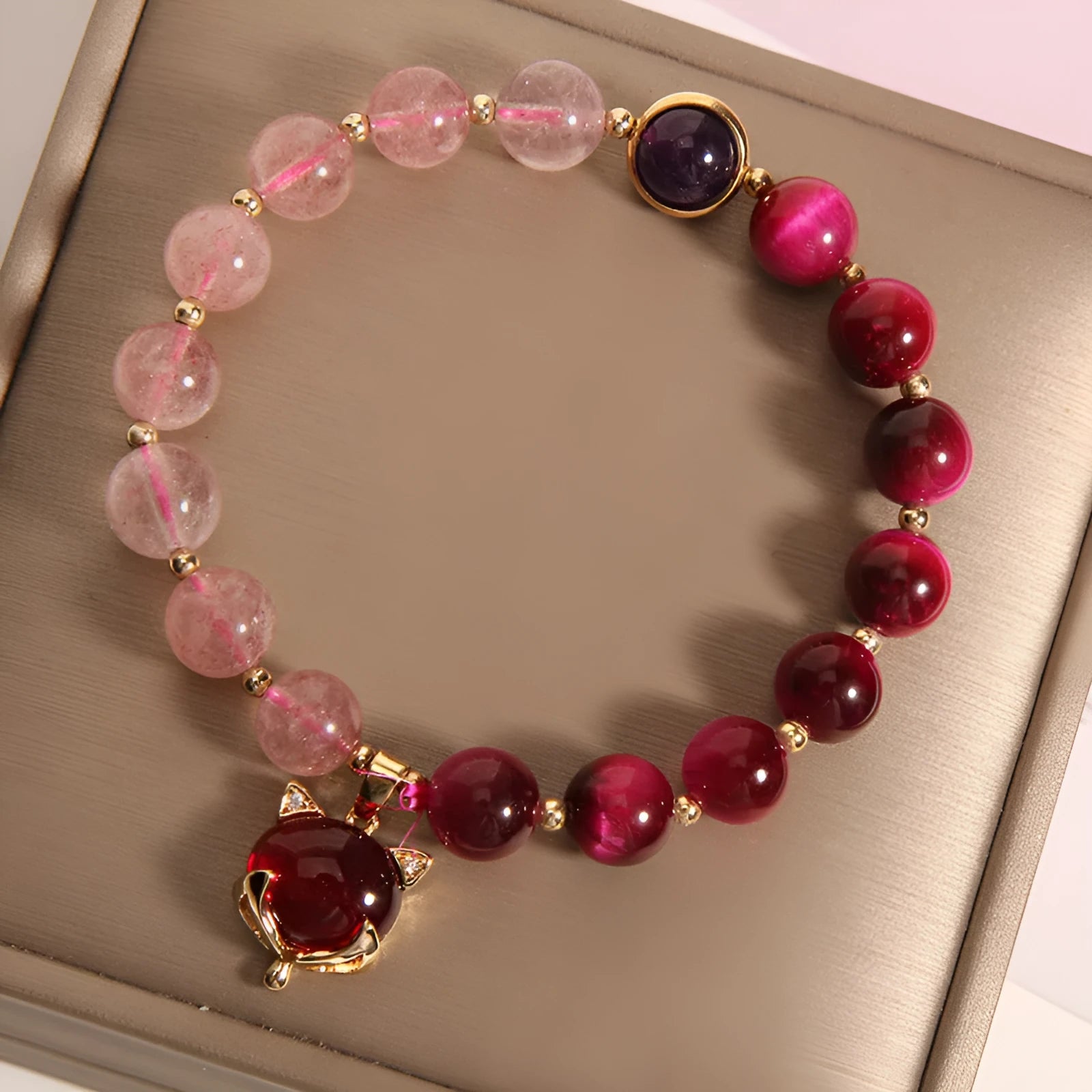 Simple women's bracelet made of transparent strawberry crystal beads on a black elastic rope.