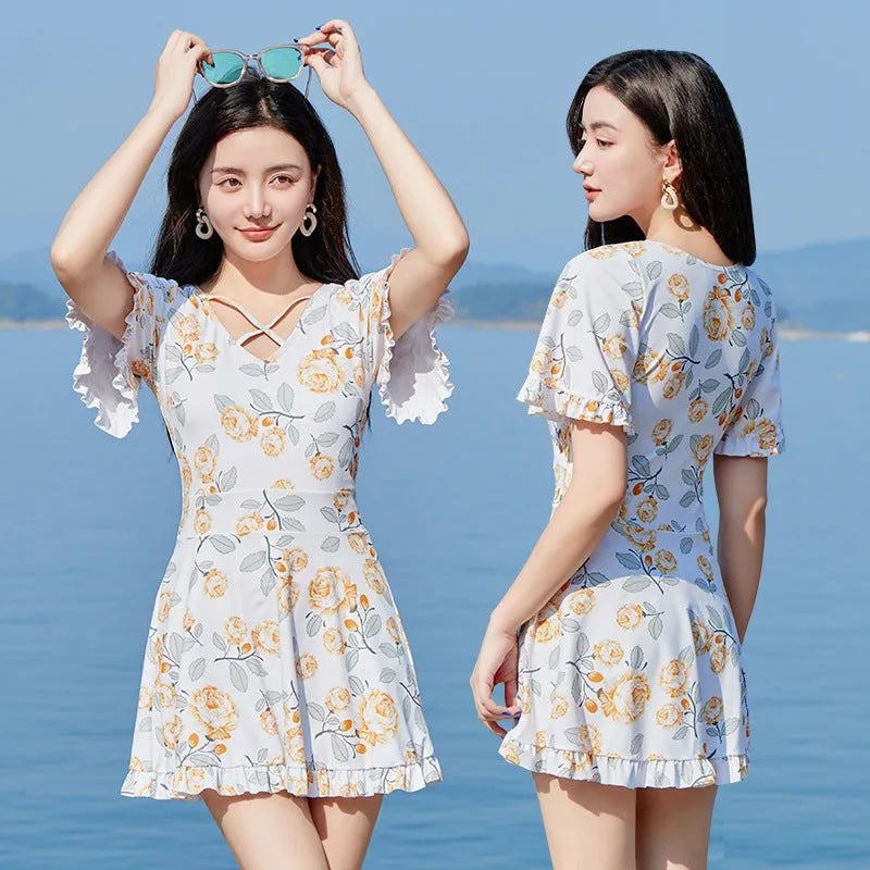 Women's high-waist one-piece swimsuit with floral print in blue and white.