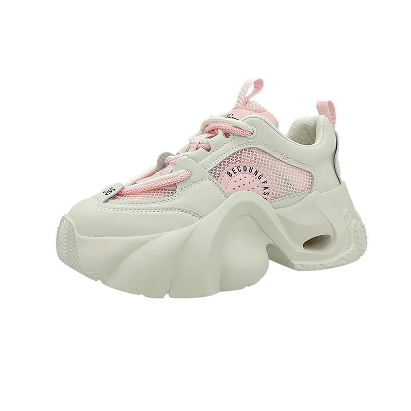 Women's beige sneakers with a thick rubber sole, cross ankle strap, and mesh lining.
