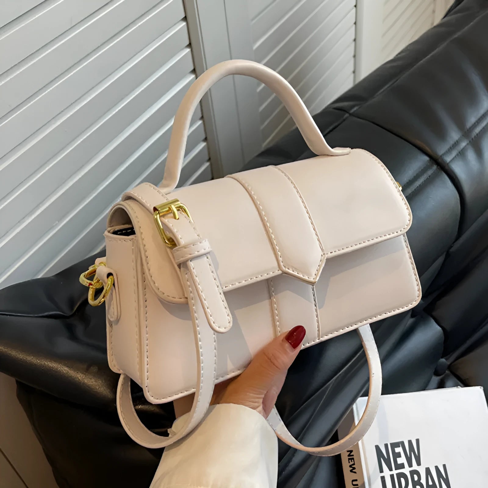 Women's beige PU messenger bag with sandwich pocket and file organiser interior.
