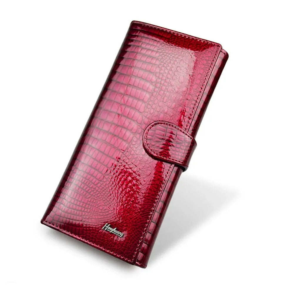 Women's red leather coin purse with crocodile pattern texture and a visible interior pigskin lining.