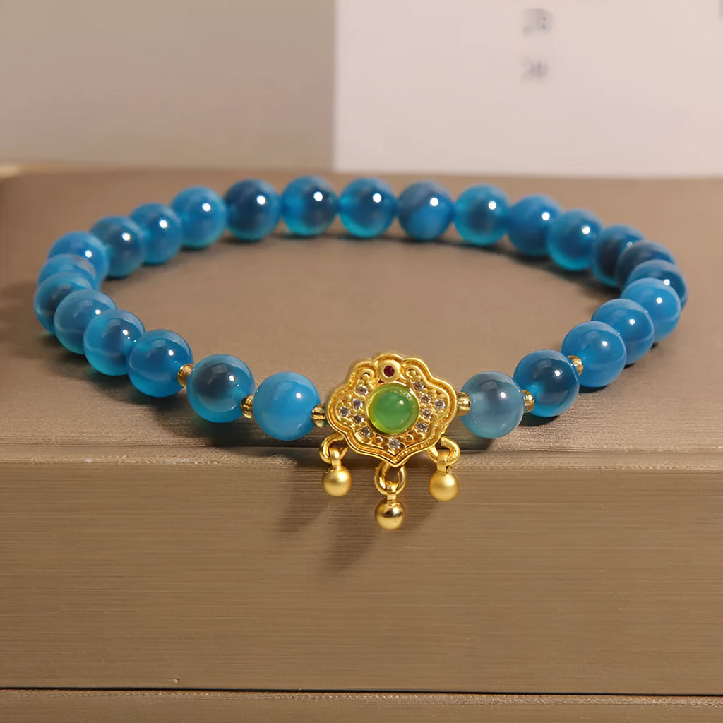 Women's blue sugar heart agate safety lock pendant bracelet with crystal and rhinestone details on alloy.