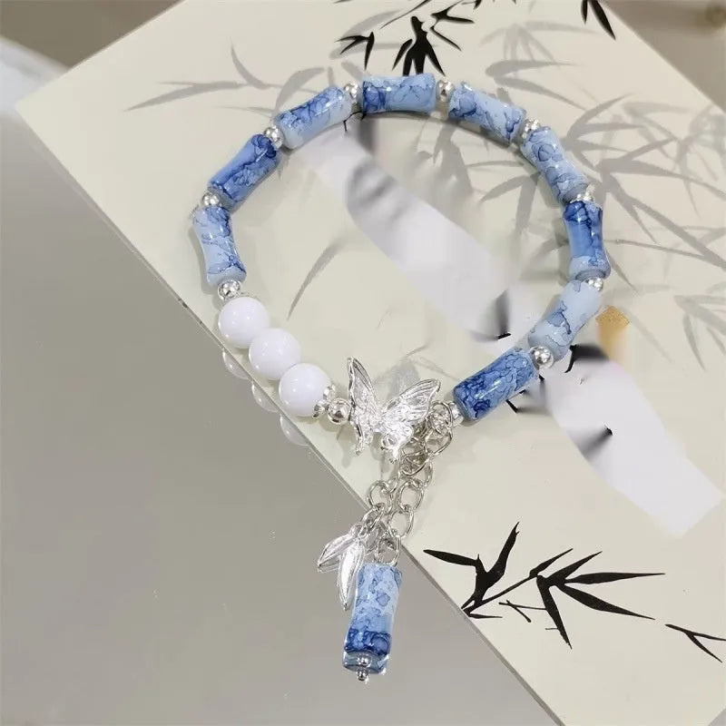 Chinese style glass bead bracelet with bamboo leaf design and manual craftsmanship details.