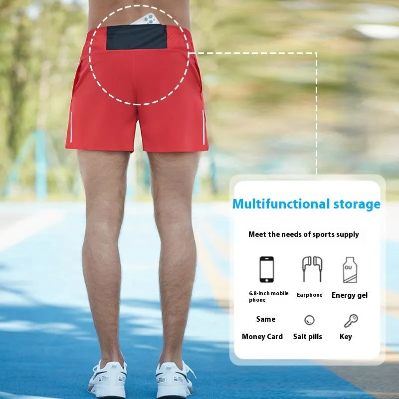 Men's red high-waist off-road running shorts with loose leg design, shown on a model running on a trail.