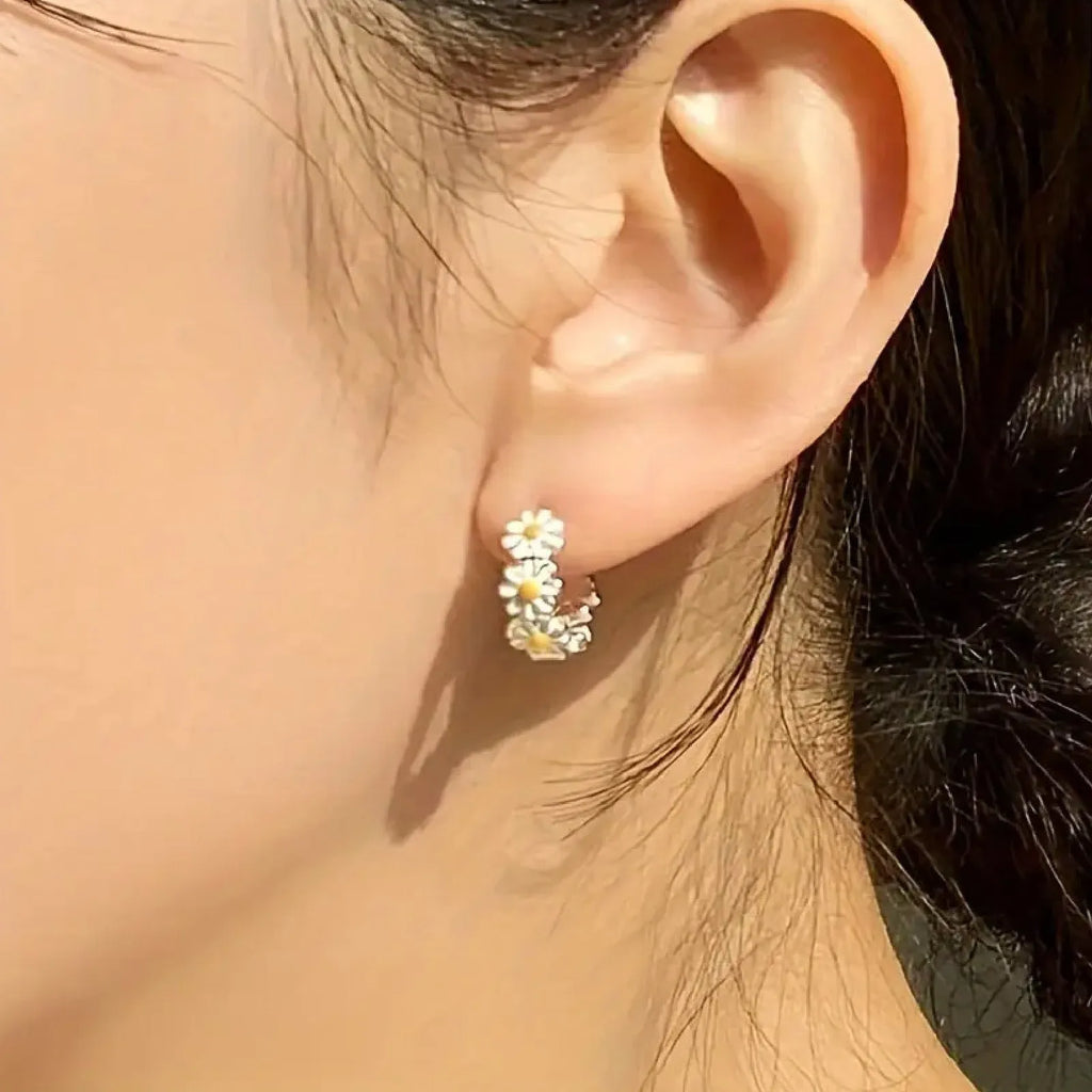 White daisy flower ring earrings with platinum gemstone accents on copper base