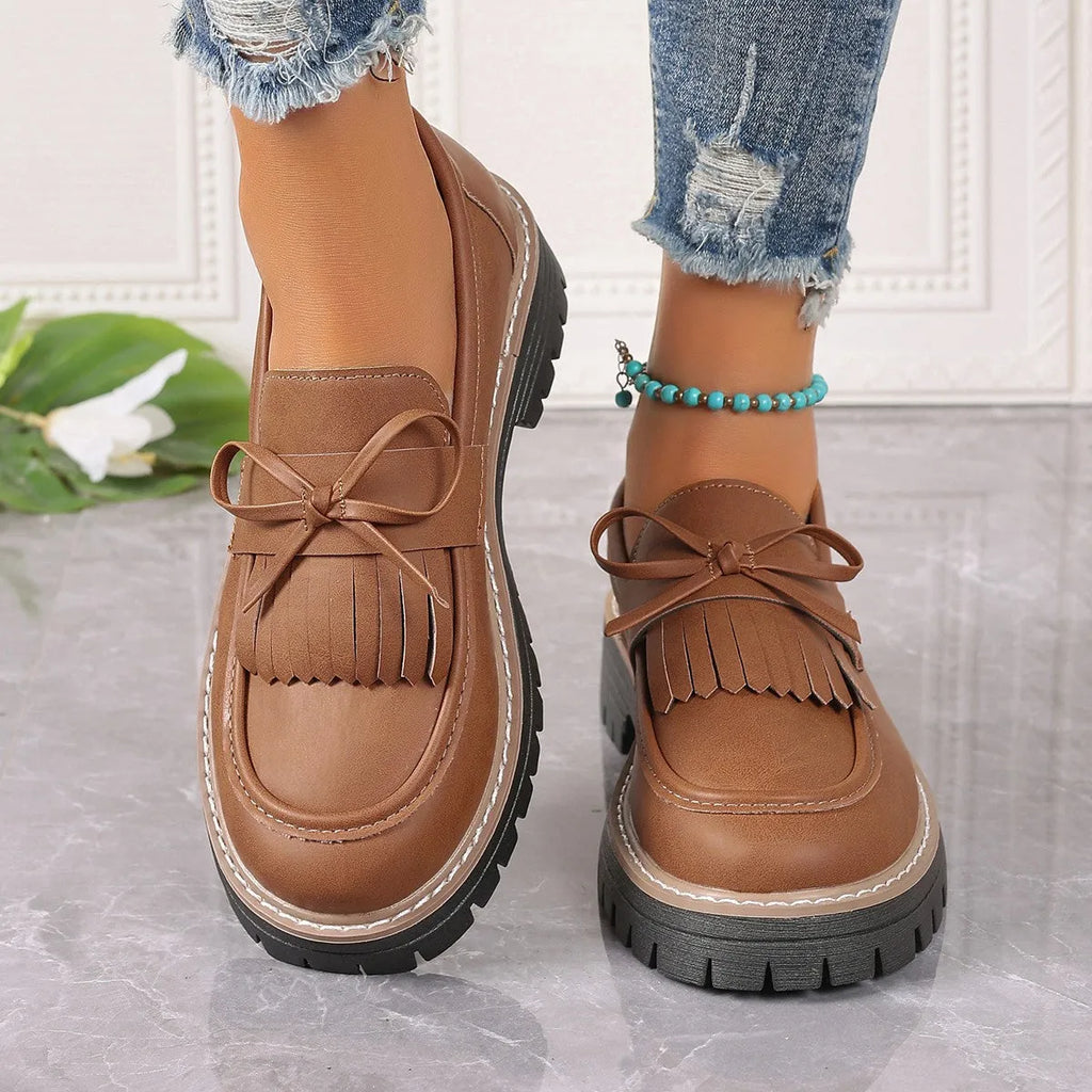 Black plus size women's loafers with a tassel and bowknot on a low-top PU upper.
