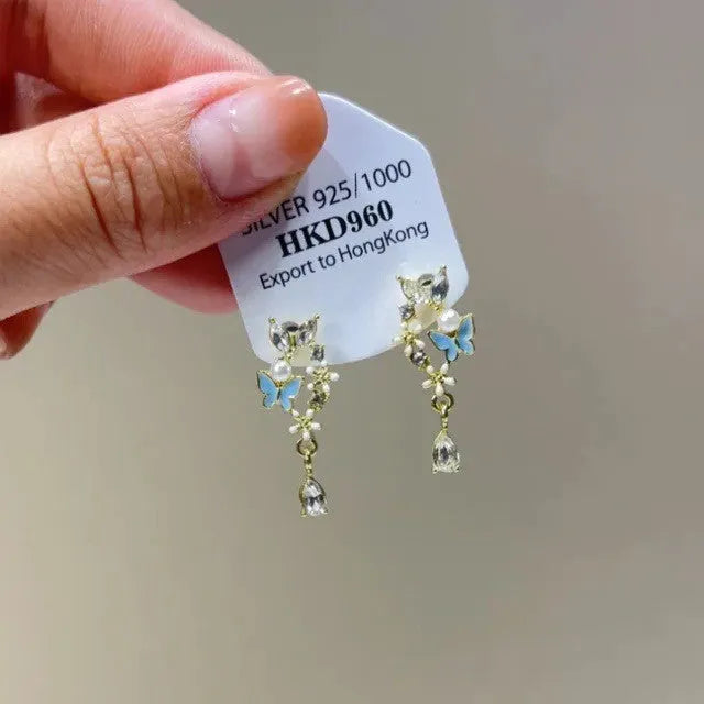 Geometric star and tassel design ear clips with rhinestone and heart details for women.