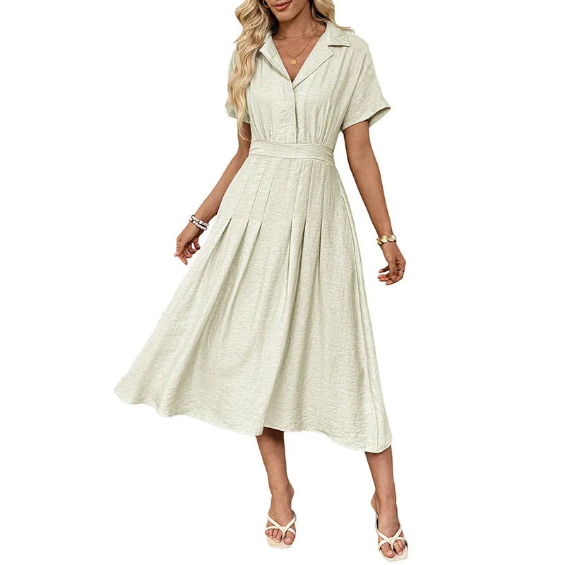 Light green women's lapel collar shirt dress with waist tie and side pockets on a dress form.