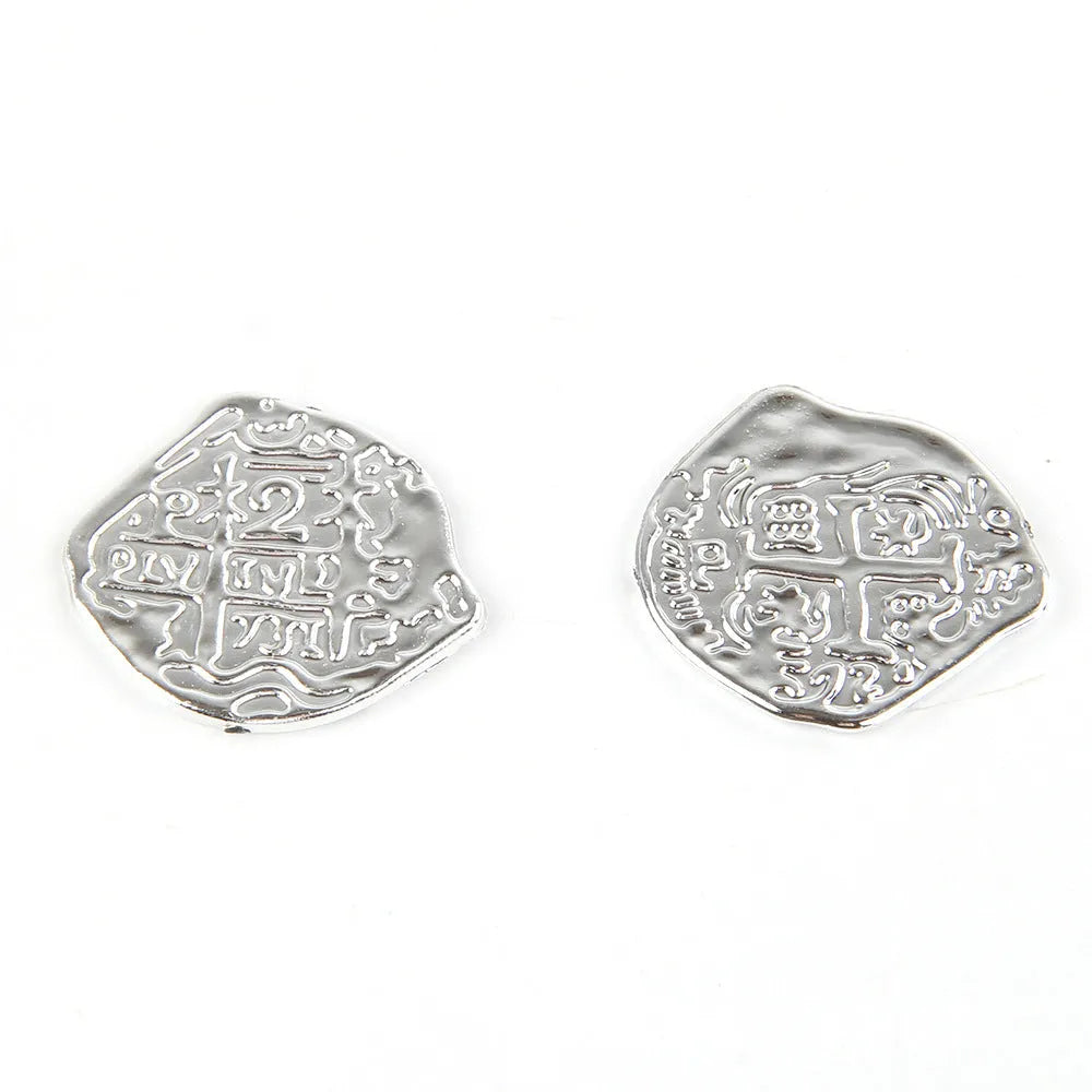 100 plastic Roman coin replicas with electroplated metallic finishes displayed together