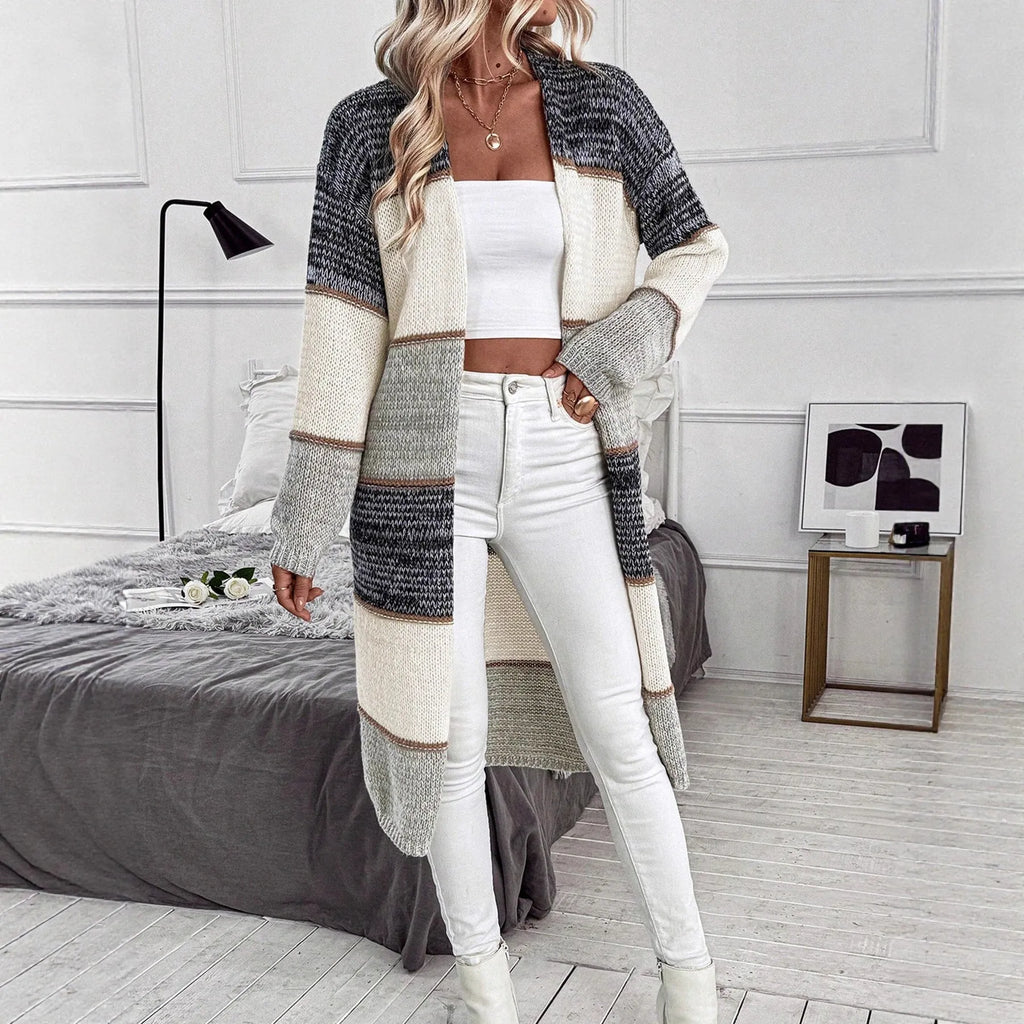 Grey women's long knitted cardigan with loose fit and long sleeves, shown in stripe or plaid pattern.