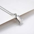 Silver curved peach heart pendant necklace on a stainless steel chain with an extension.