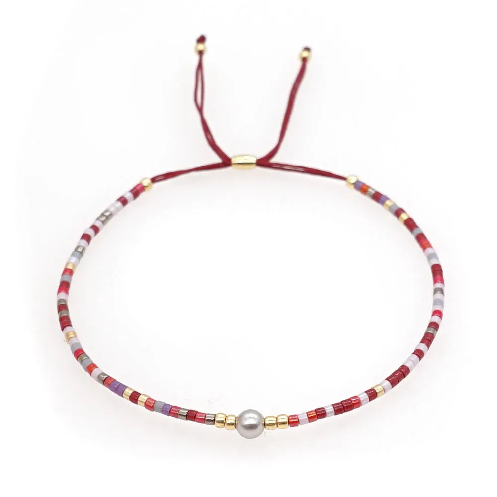Handmade colourful beaded bracelet with geometric stone and glass beads on a wrist