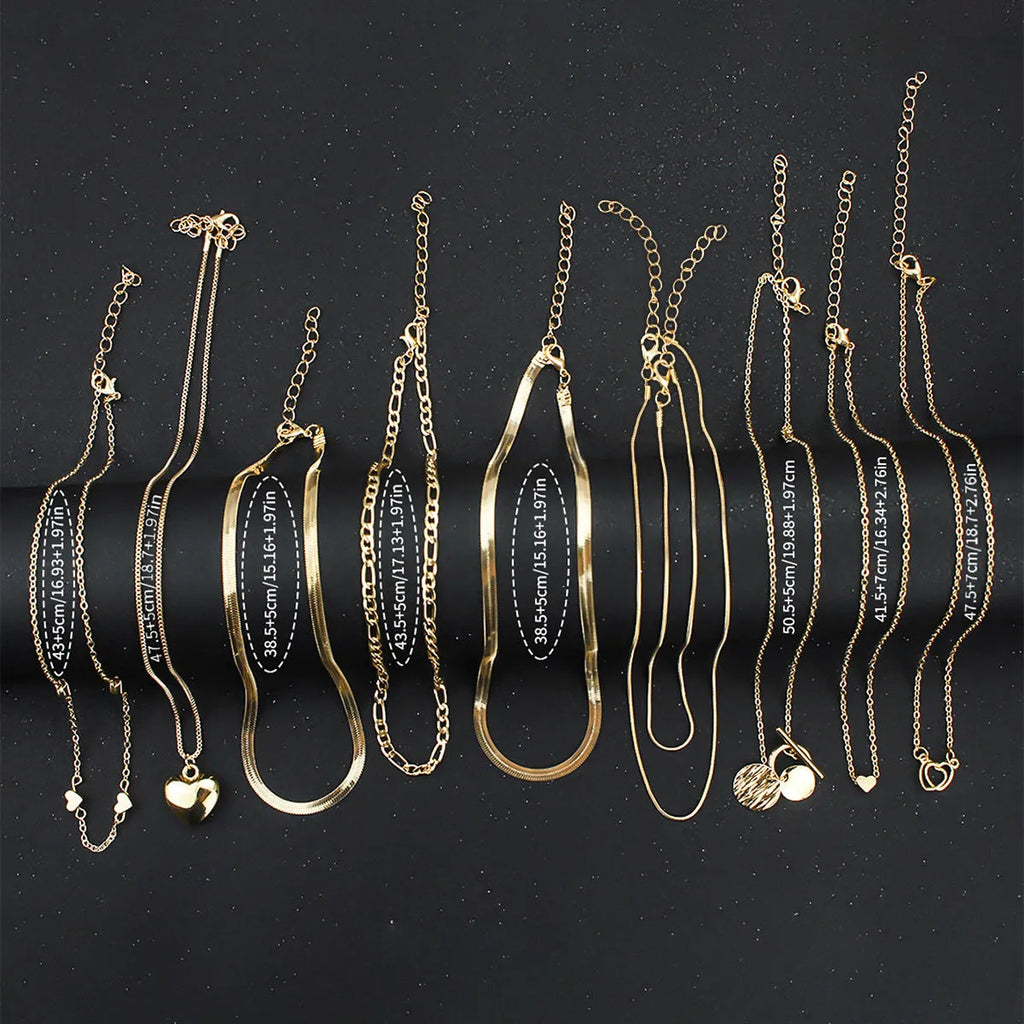 Set of ten gold-coloured women's necklaces with snake bones chains and alloy pendants.