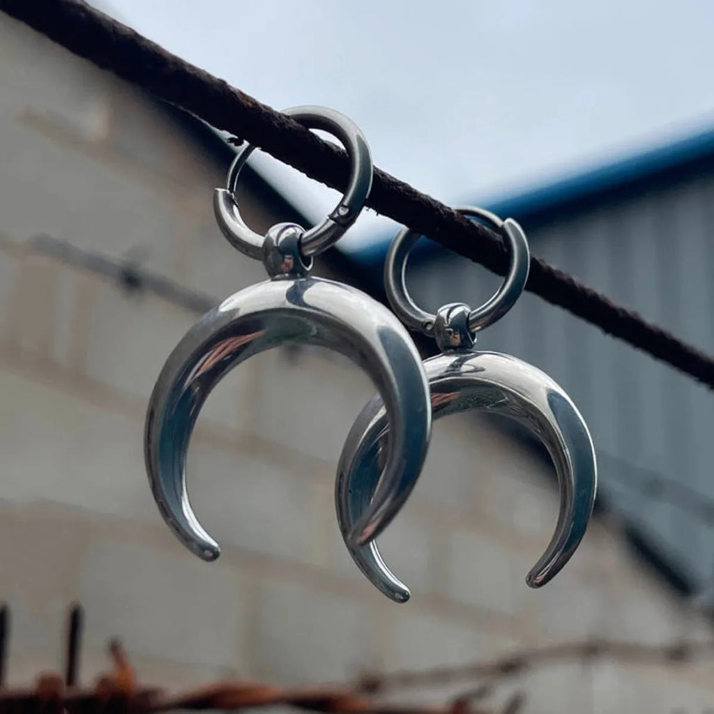 Silver big hoop earrings with a geometric shape and gothic moon design.