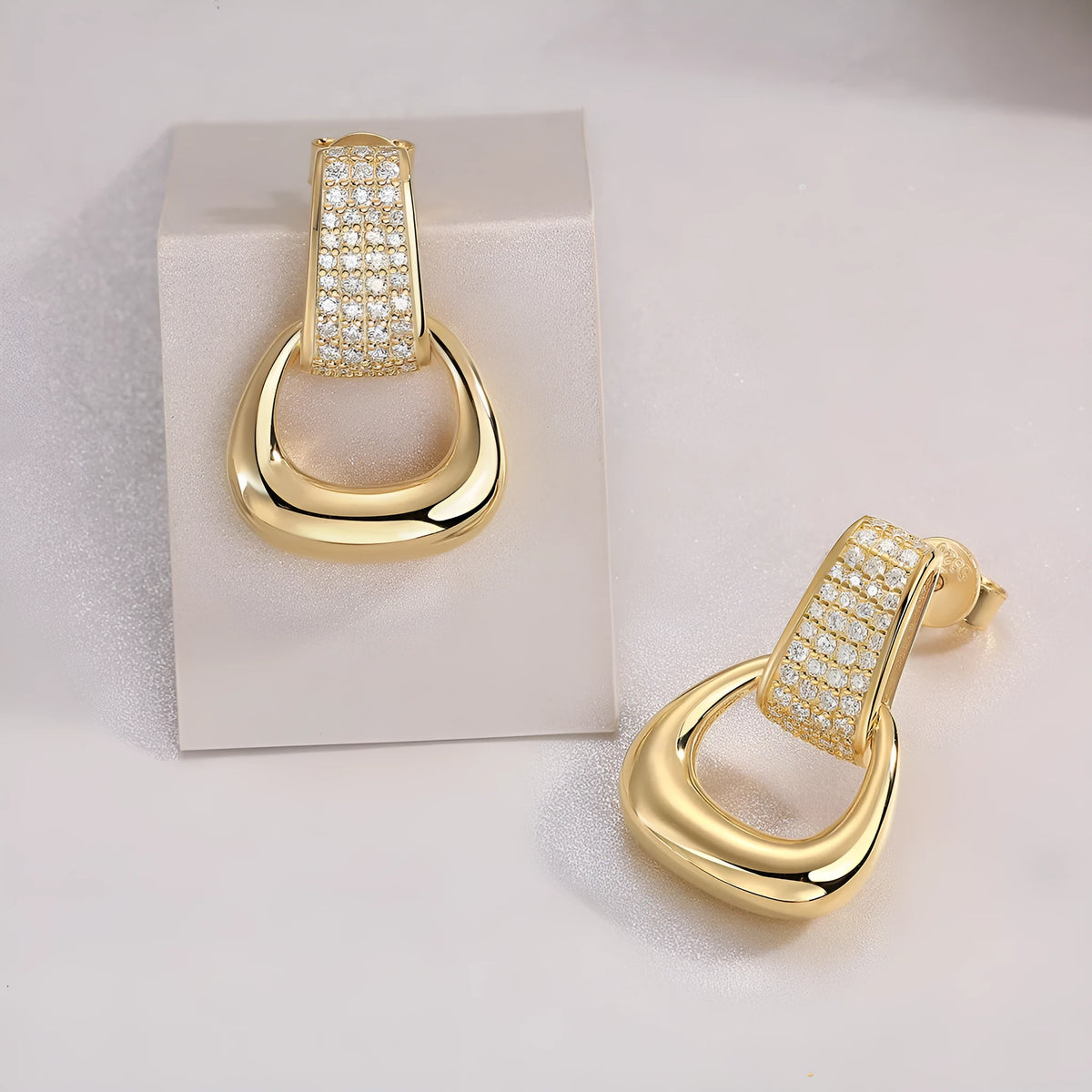 Pair of silver moissanite stud earrings with geometric shape and round popular element