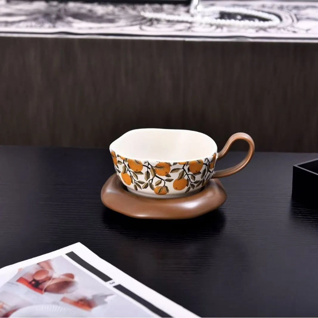 Antique style ceramic coffee cup and saucer set with medieval pattern in black or orange