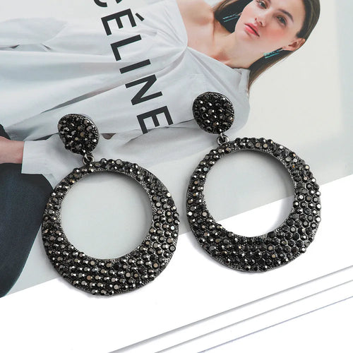 A pair of large round colour alloy pendant earrings with a cartoon style and diamond details for women.